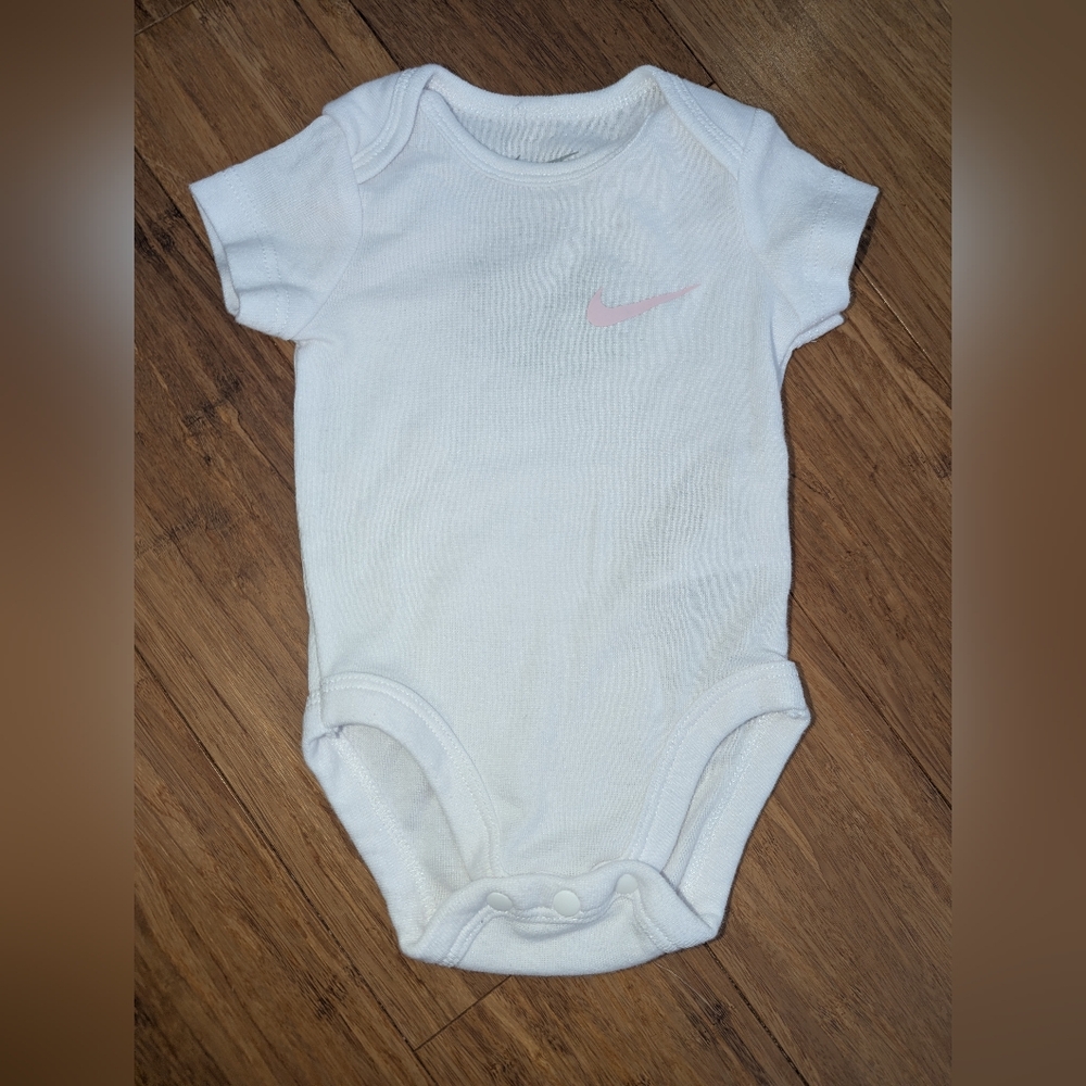 Nike White Baby Bodysuit with Light Pink Swoosh
